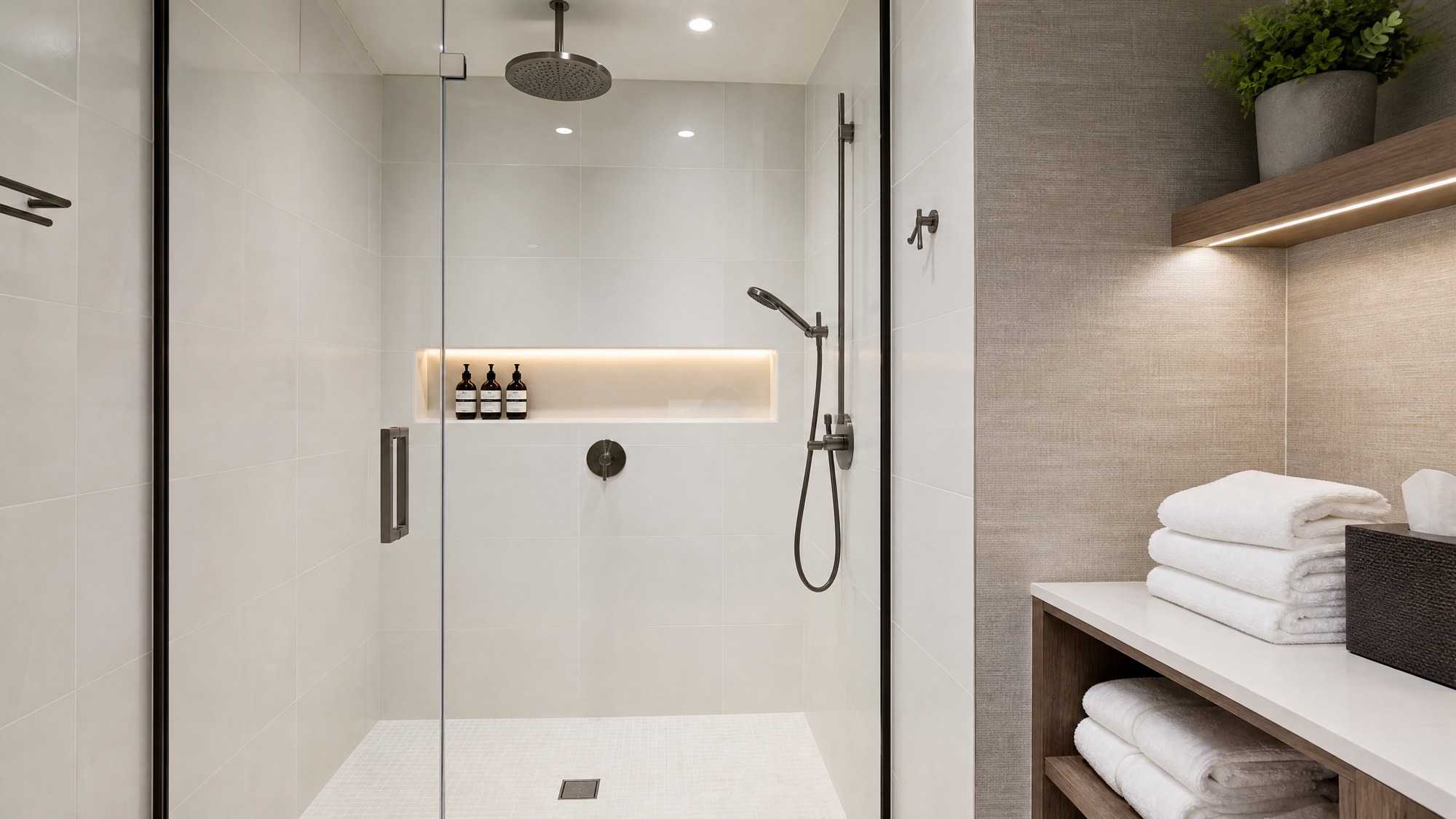 A sleek modern clean shower room in a premium office environment, glass door, luxury rain shower head, clean white minimalist tiles, fresh towels ready, warm professional lighting, photorealistic, --ar 16:9